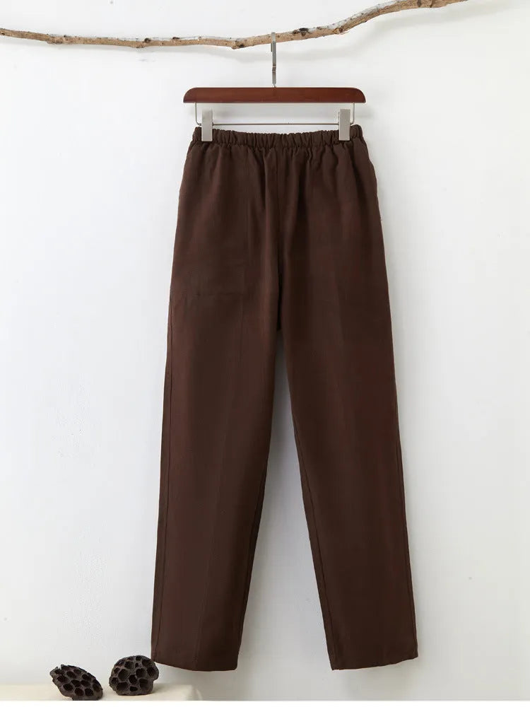 Man wearing beige pure cotton casual trousers with a drawstring waist and belt.