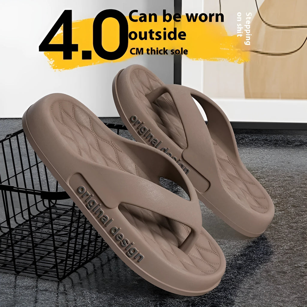 Men's black EVA flip flops with injection-moulded sole on a sandy beach.