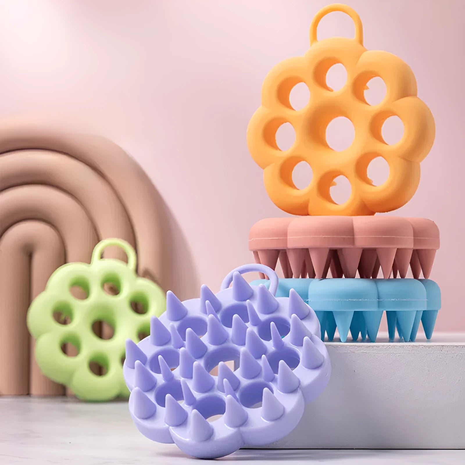 Blue silicone pet grooming brush with soft bristles and an ergonomic massage handle on a white background.