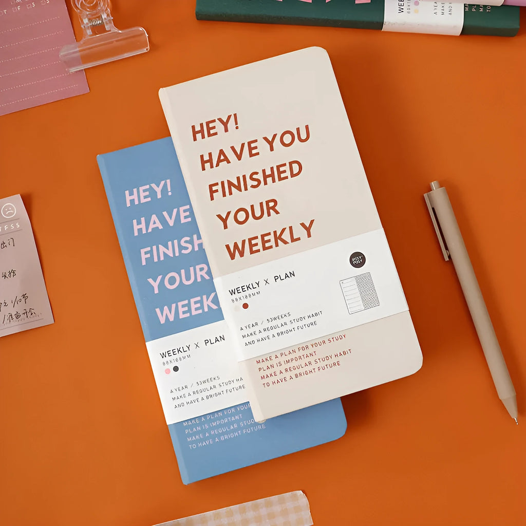Weekly plan diary handbook with blue cover open to show a weekly layout on its 100 pages.
