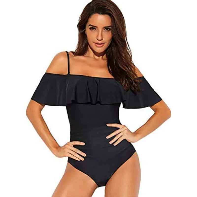 Black one-piece swimsuit with cut-out design and ruffled straps on a mannequin.