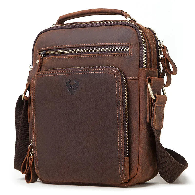 Men's brown genuine leather single-shoulder crossbody bag with visible stitching, shown on a model.