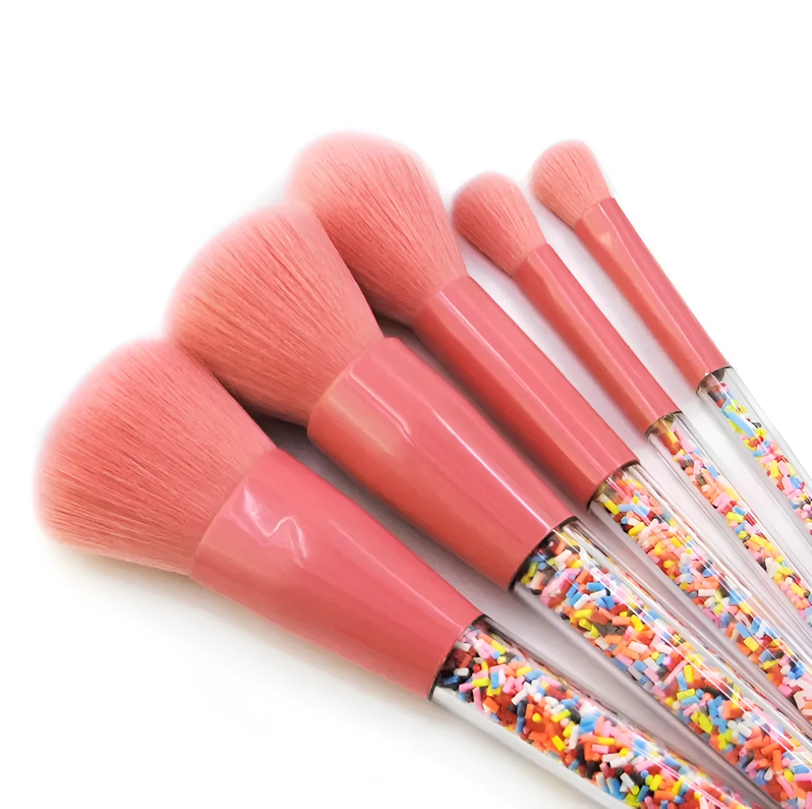 5 candy makeup brushes with colourful acrylic handles, fibre hair bristles, and aluminium ferrules on a white background