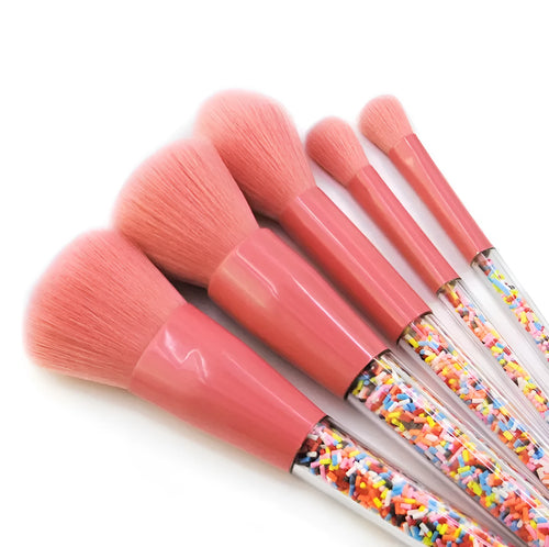 5 candy makeup brushes with colourful acrylic handles, fibre hair bristles, and aluminium ferrules on a white background