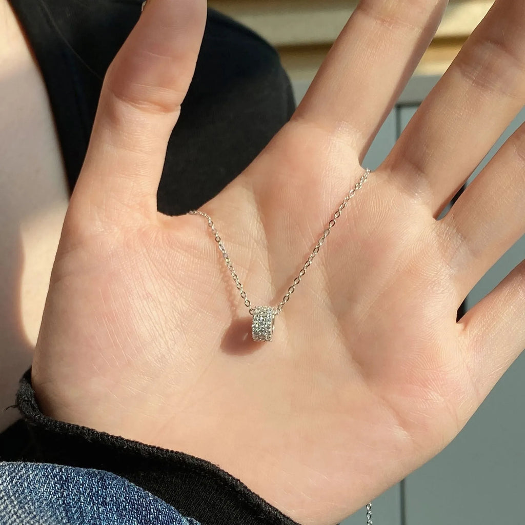 925 silver necklace with small waist pendant and platinum electroplate finish on white background