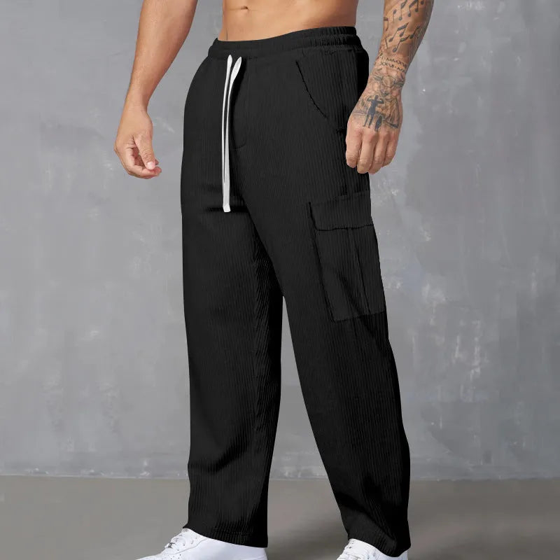 Men's loose-fitting corduroy cargo trousers in a straight-leg cut, shown in a solid colour.
