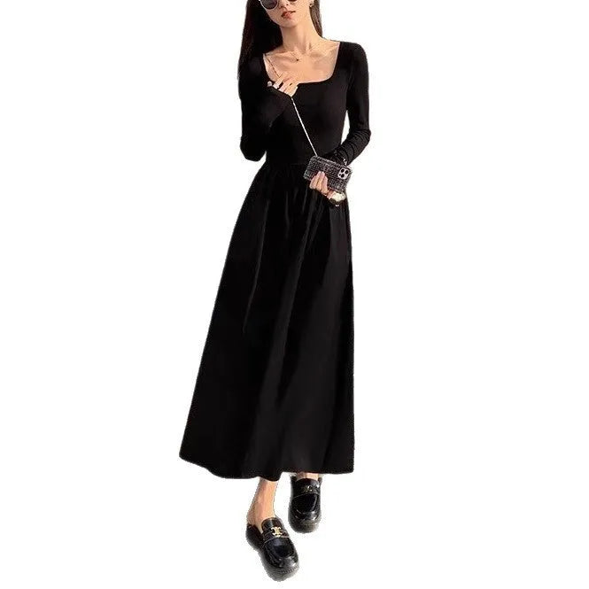 Black square collar knitted A-line dress with elastic waist and long sleeves on a model