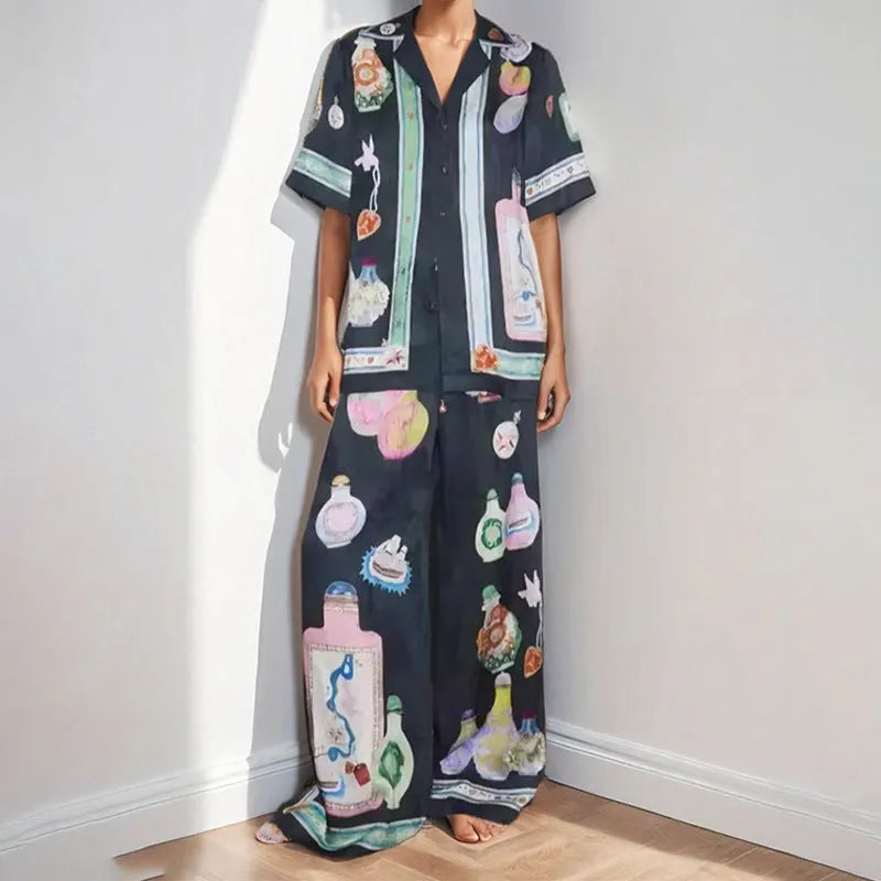 Black women's cardigan and trousers set with cartoon animation print, shown as a two-piece outfit.