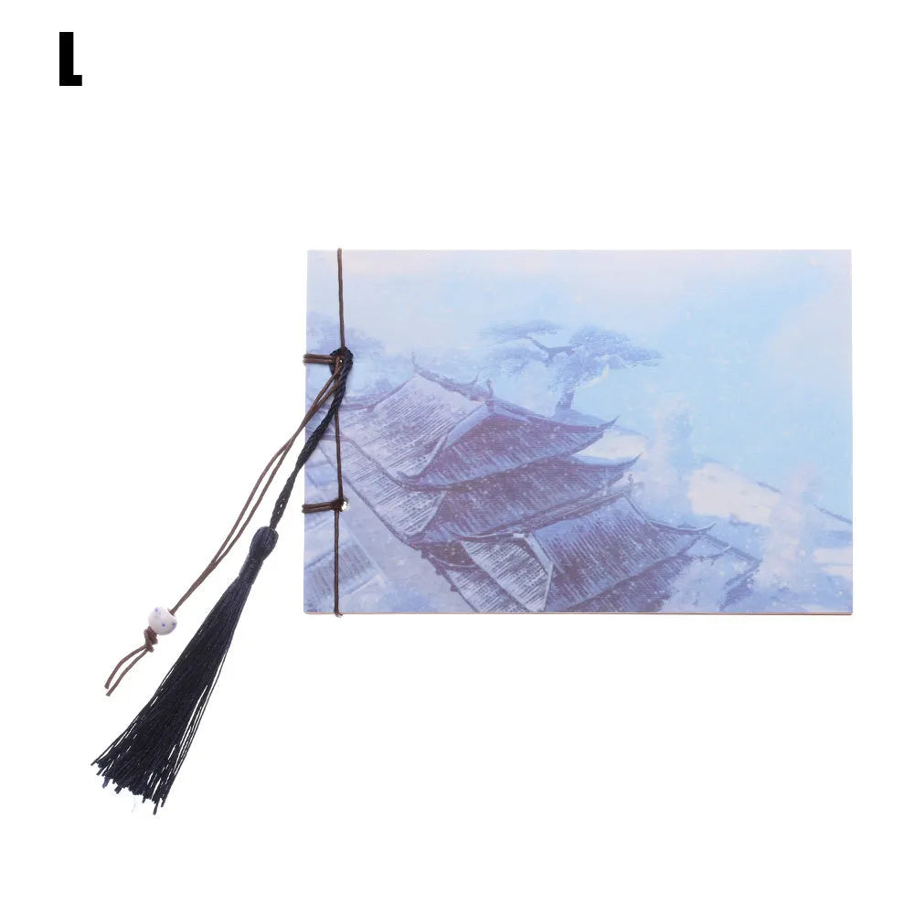 Hand-stitched kraft paper notebook with tassel bookmark on blank pages.