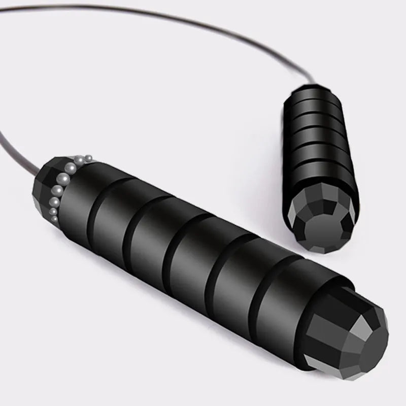 Steel wire skipping rope with black foam handles on a flat surface, showing 3m length and 4mm rope diameter