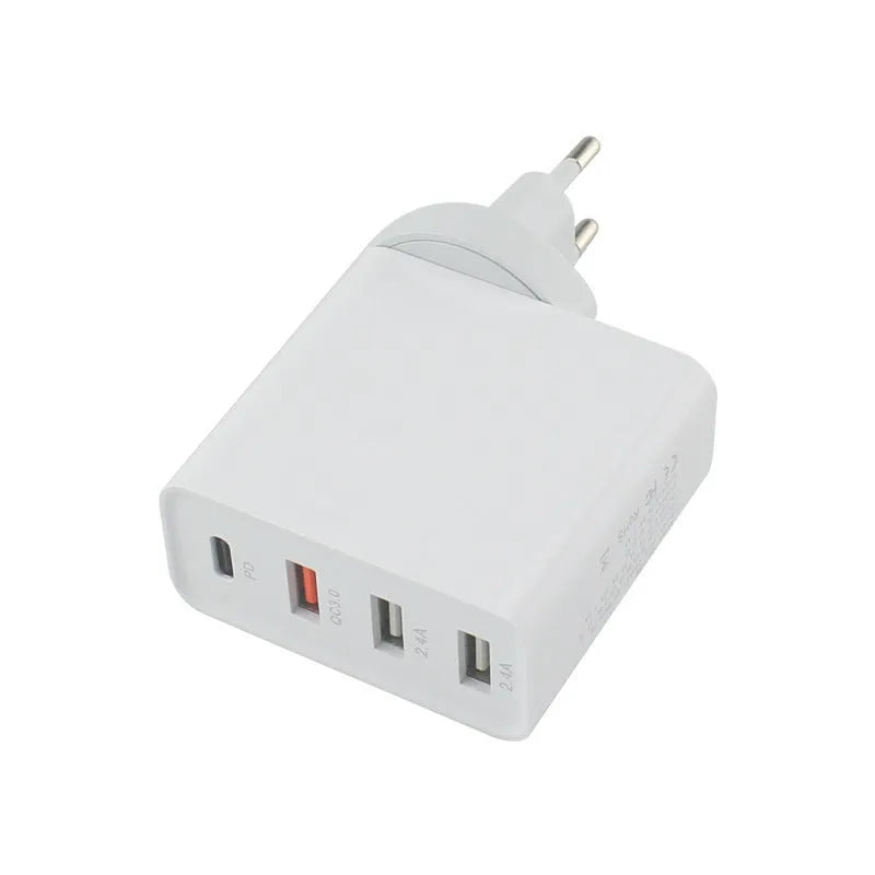 Black and white four-port USB-C wall charger with interchangeable UK, US, EU, and AU plug heads.