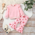 Pink two-piece girls' suit with long sleeve flounced sleeve knitted sweater, printed bow, and flared pants on white background