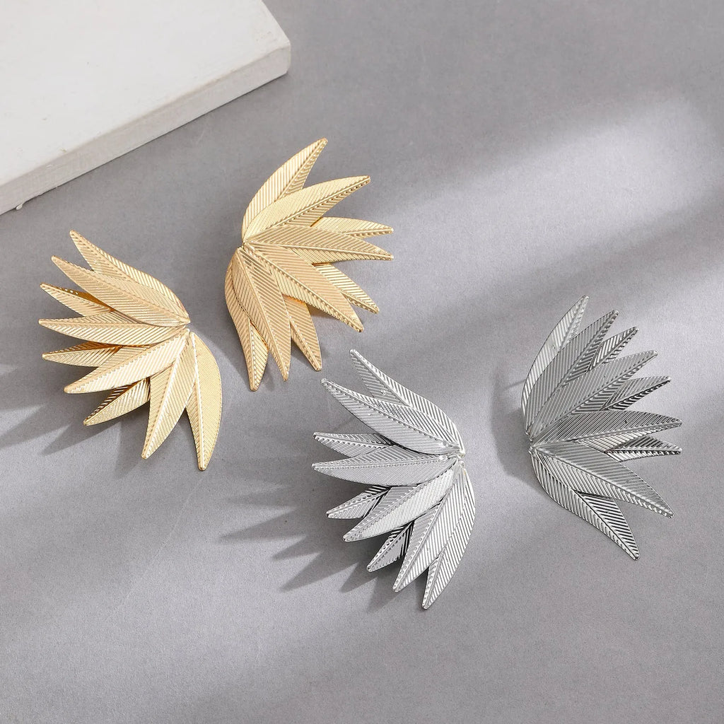 Leaves patch earrings in gold and white colour options with geometric leaf silhouette design