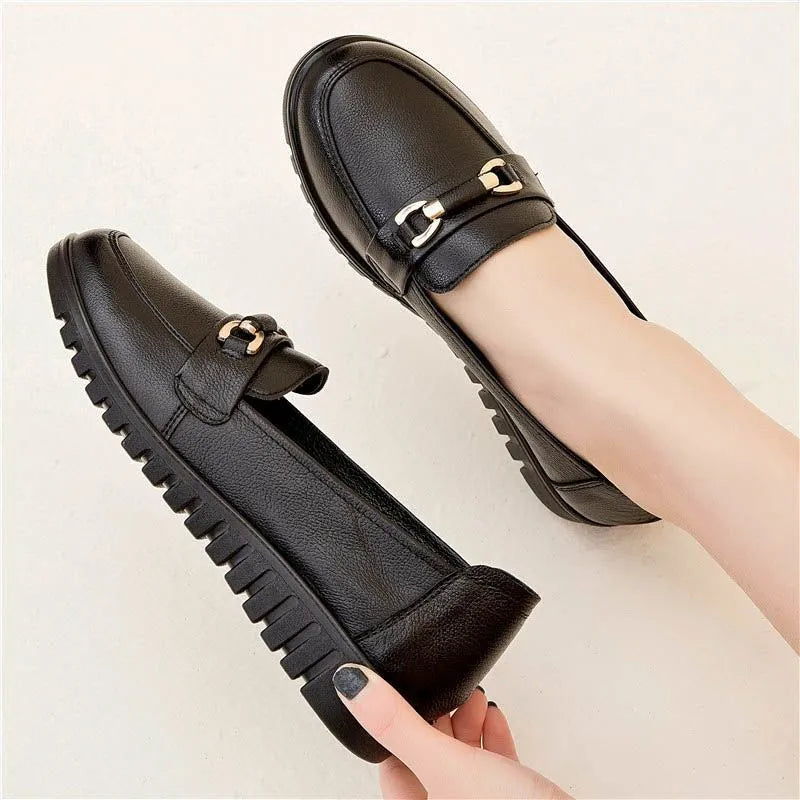 Black soft-leather casual pumps with round toe, low flat heel, and rubber sole.