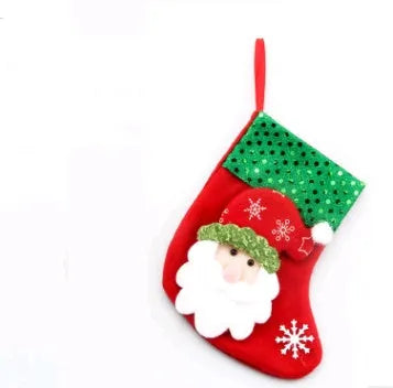 Red cloth Christmas sock with sequin detail hanging on tree branch