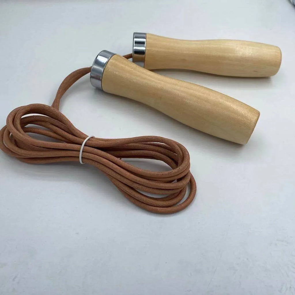 Real cowhide leather jump rope with solid wood handles and denim grip on grey background