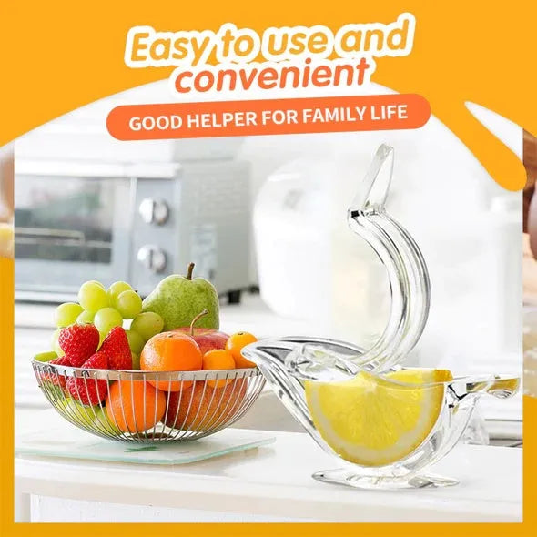 Clear acrylic bird-shaped manual lemon juicer on a kitchen counter