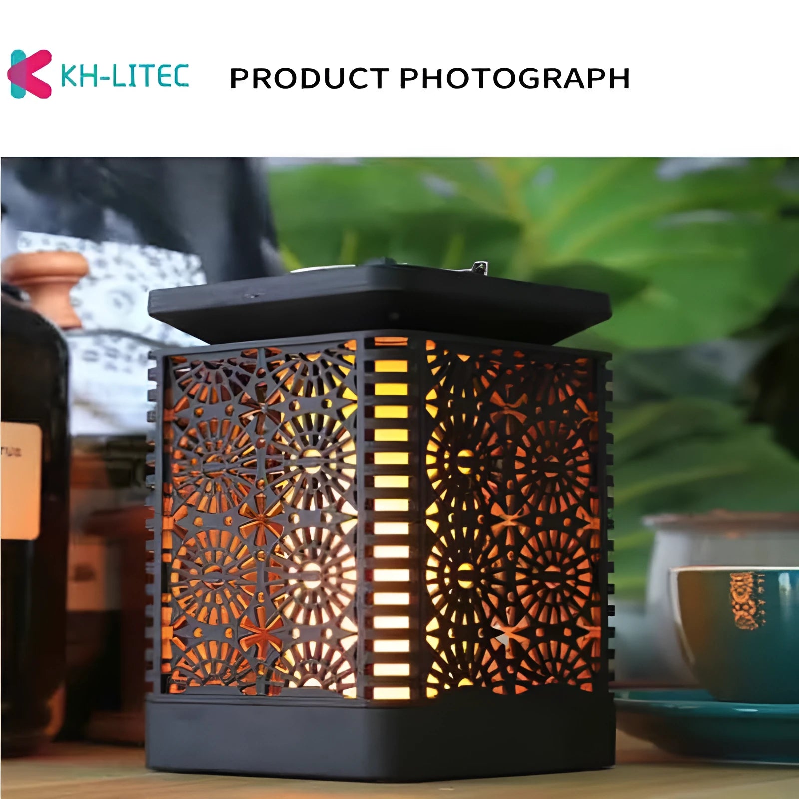 Set of four black solar-powered flame effect LED lanterns for outdoor garden decoration.