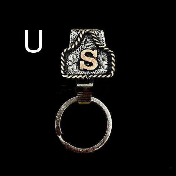 Handmade metal cow tag style key holder shown in one of its 26 colour options, attached to a keyring.