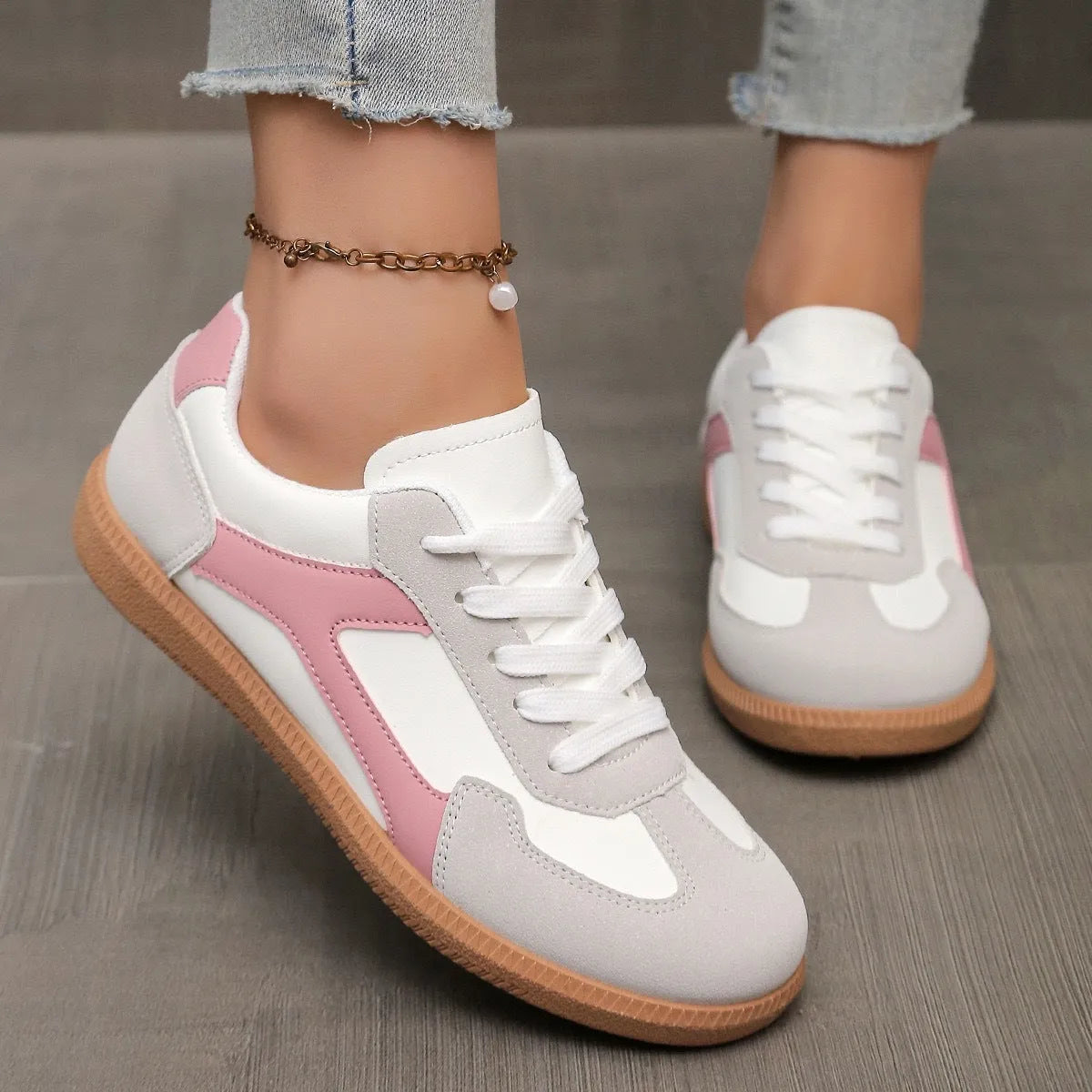 A pair of retro-style low-top lace-up sneakers in a selected colour on a plain background.