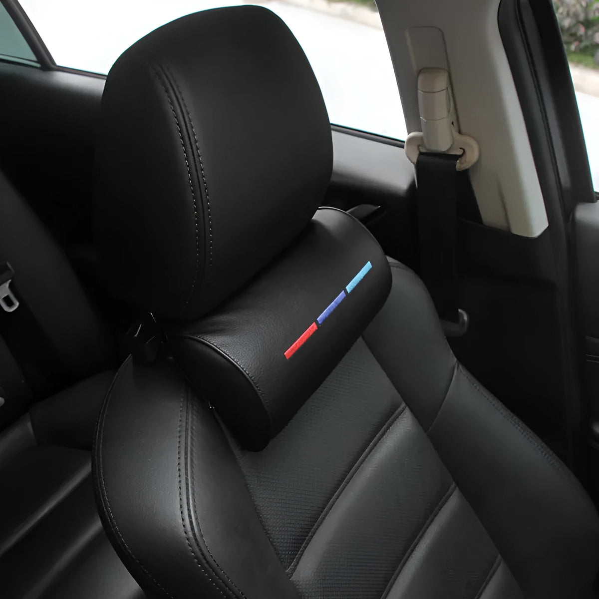 Black cotton car seat neck pillow on a car headrest for neck support