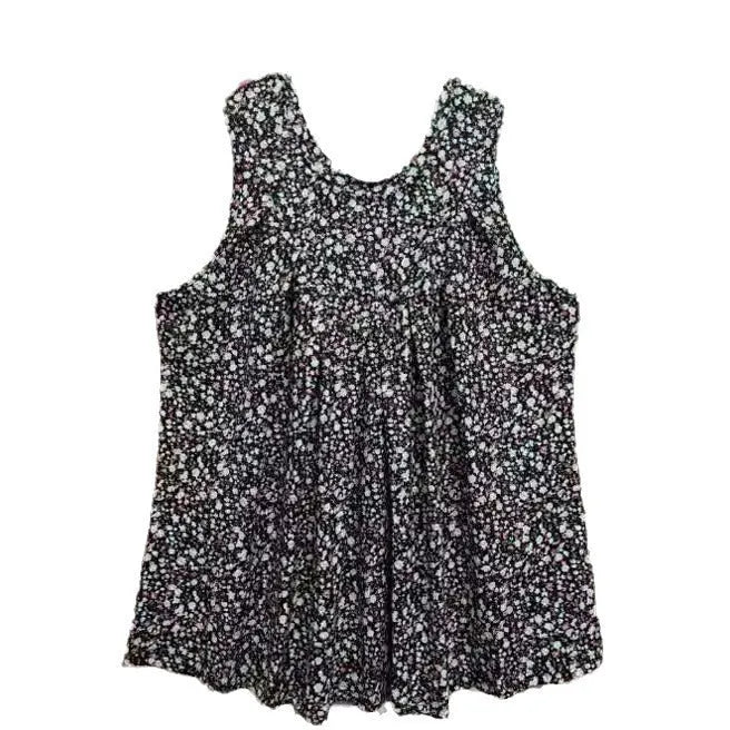 A black floral print sleeveless vest on a hanger, showing its loose fit and round neck design.