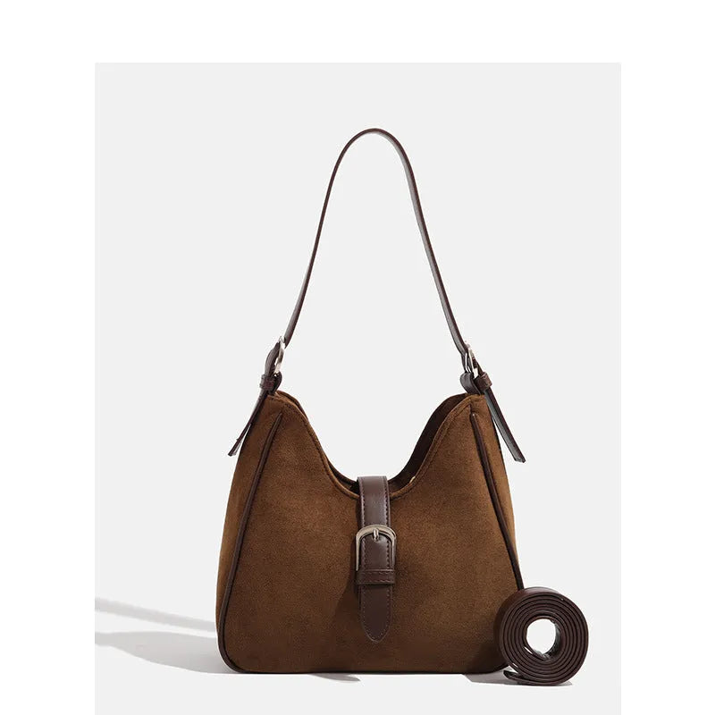 Retro suede leather underarm shoulder bag in brown with double connector straps on a white background