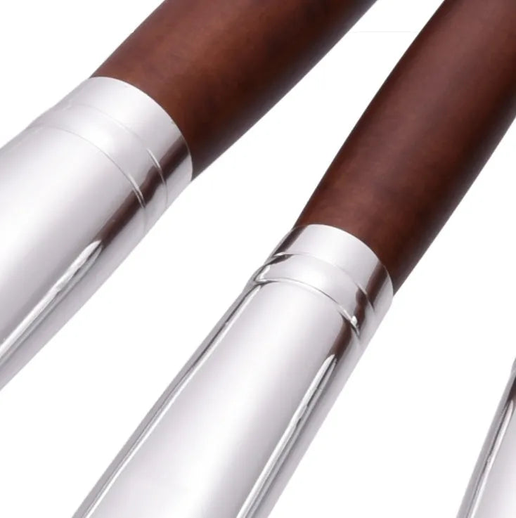 10 brown makeup brushes with wooden handles and nylon bristles laid out on a flat surface
