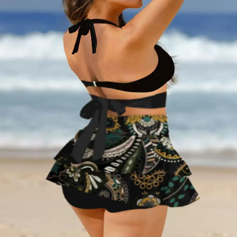 Women's black lace-up bikini top with matching high-waist swim skirt laid flat.