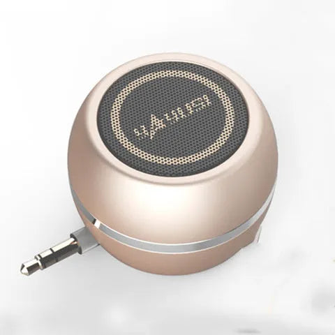 A5 portable mini speaker in red with 3.5mm audio plug and ABS plastic casing on a table