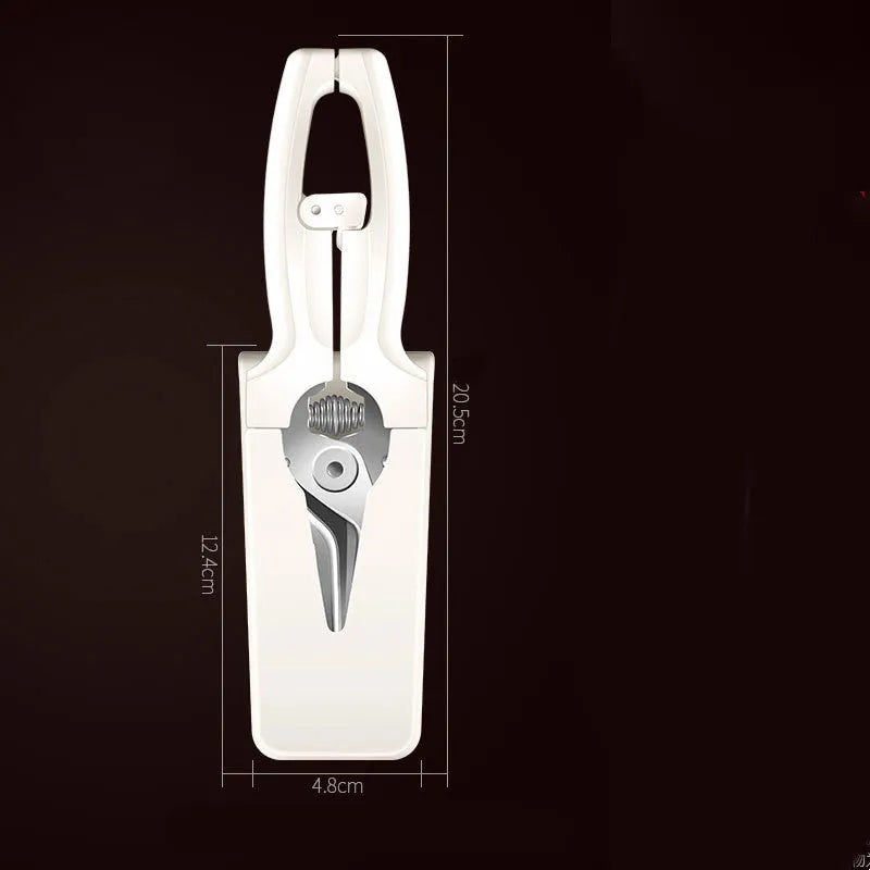 Creative magnetic suction kitchen scissors in stainless steel on a fridge door