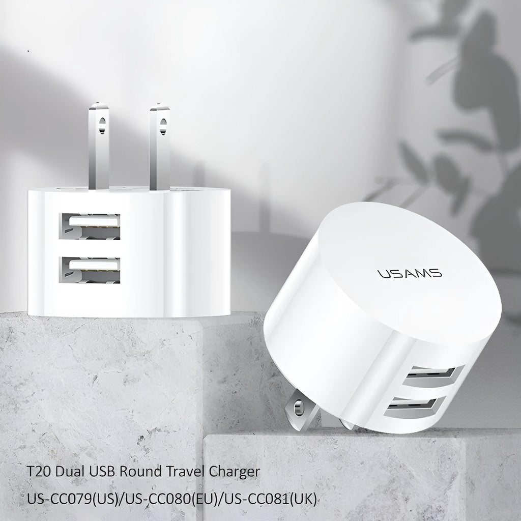 White portable universal dual USB phone charger showing US, EU and UK plug compatibility