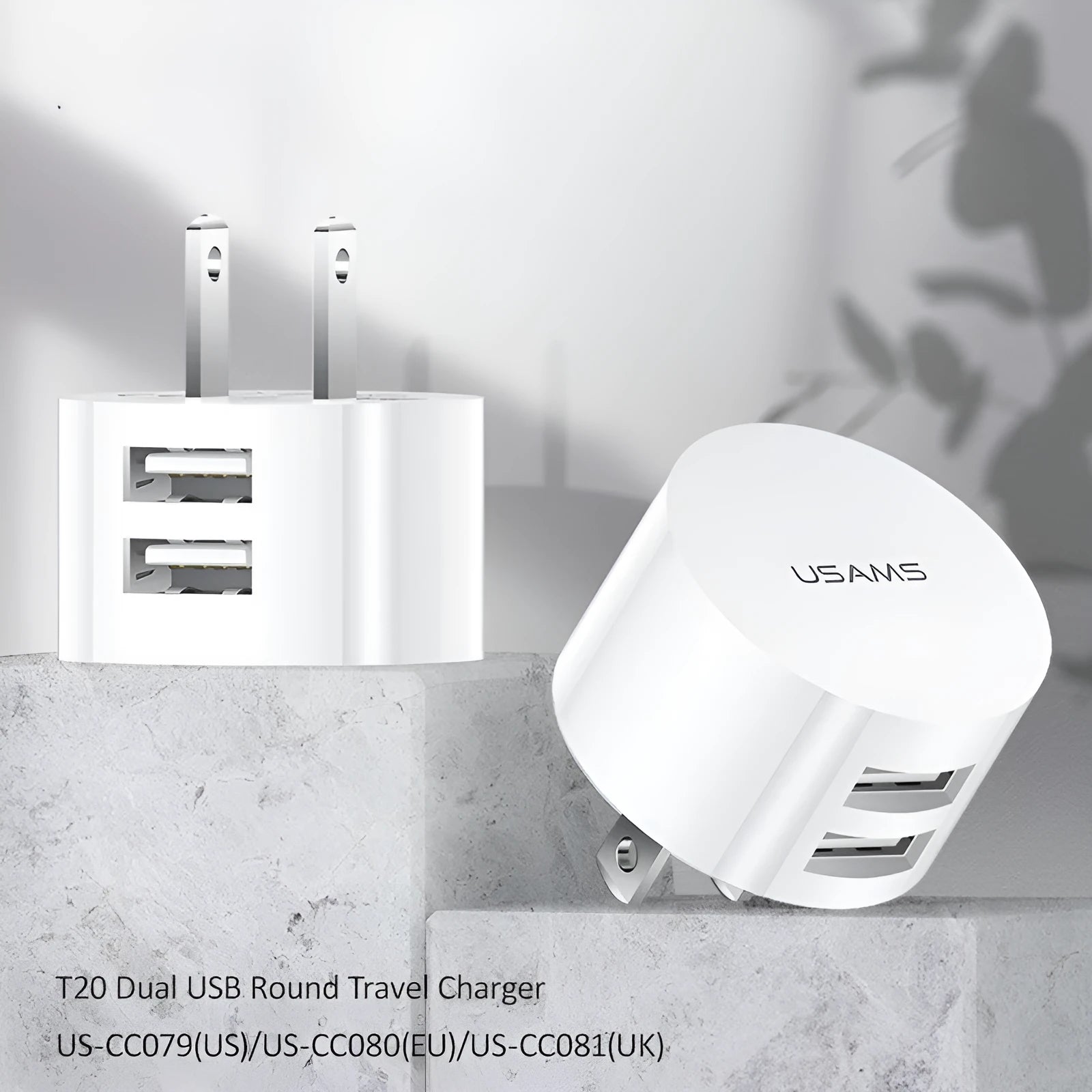 White portable universal dual USB phone charger showing US, EU and UK plug compatibility