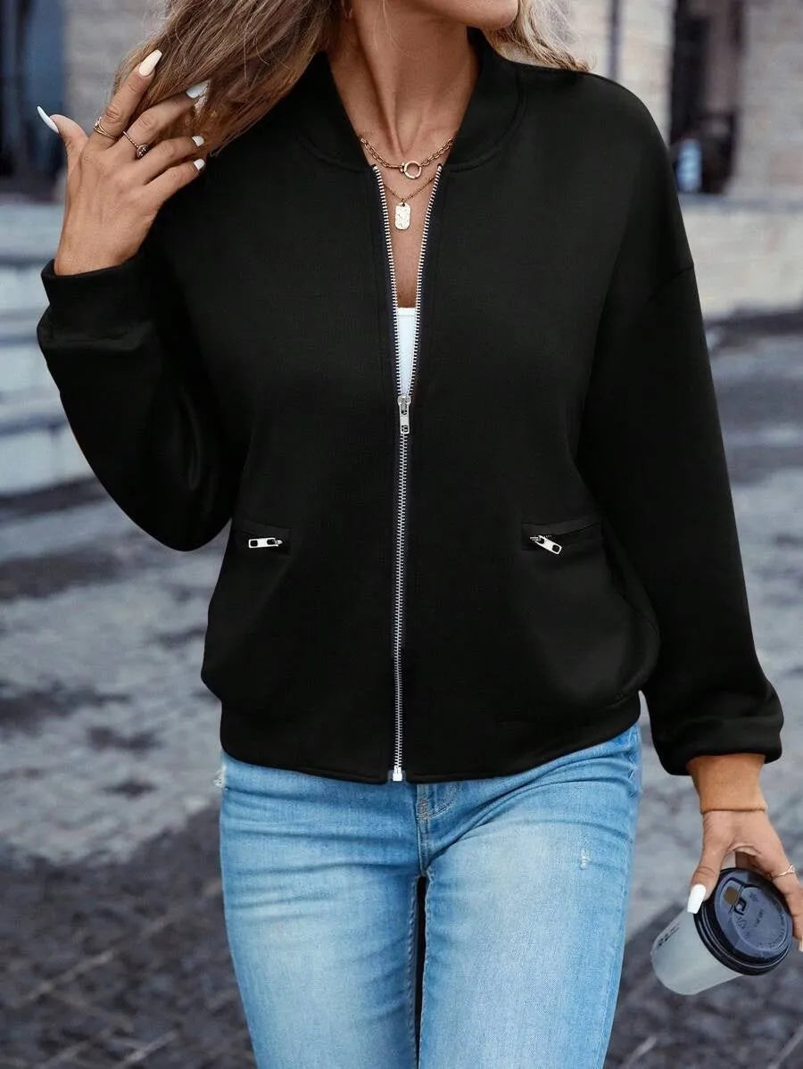 A black women's casual zip-up jacket with long sleeves on a hanger.