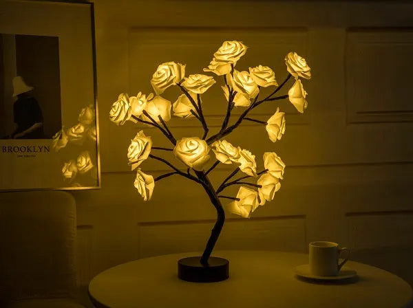 White and red rose flower LED table lamp with bonsai tree lights on a table.