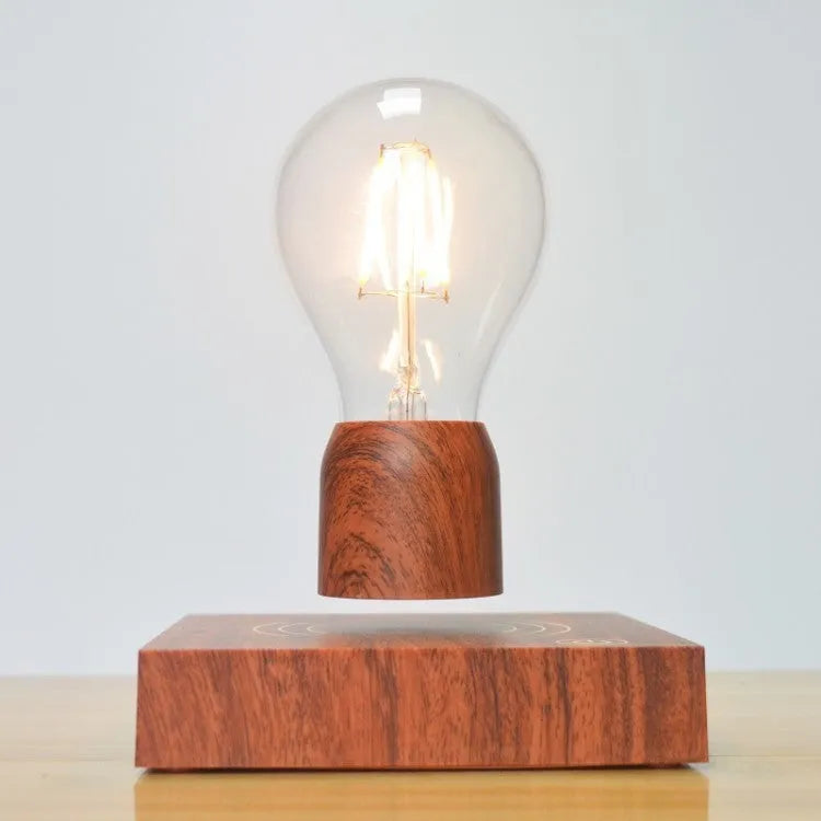 Magnetic levitation light bulb floating above its imitation wood base.