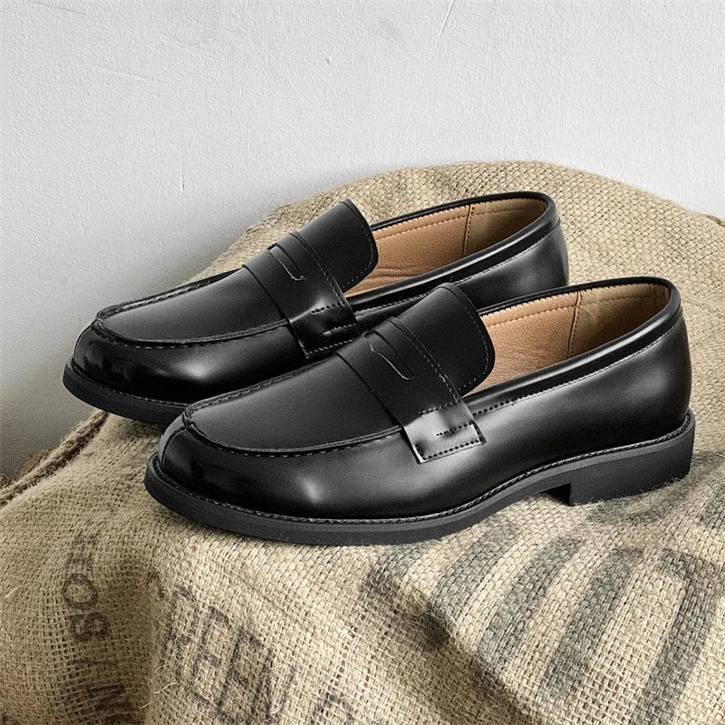 Black men's classic slip-on derby leather shoes with a rubber sole, shown in a mature style.