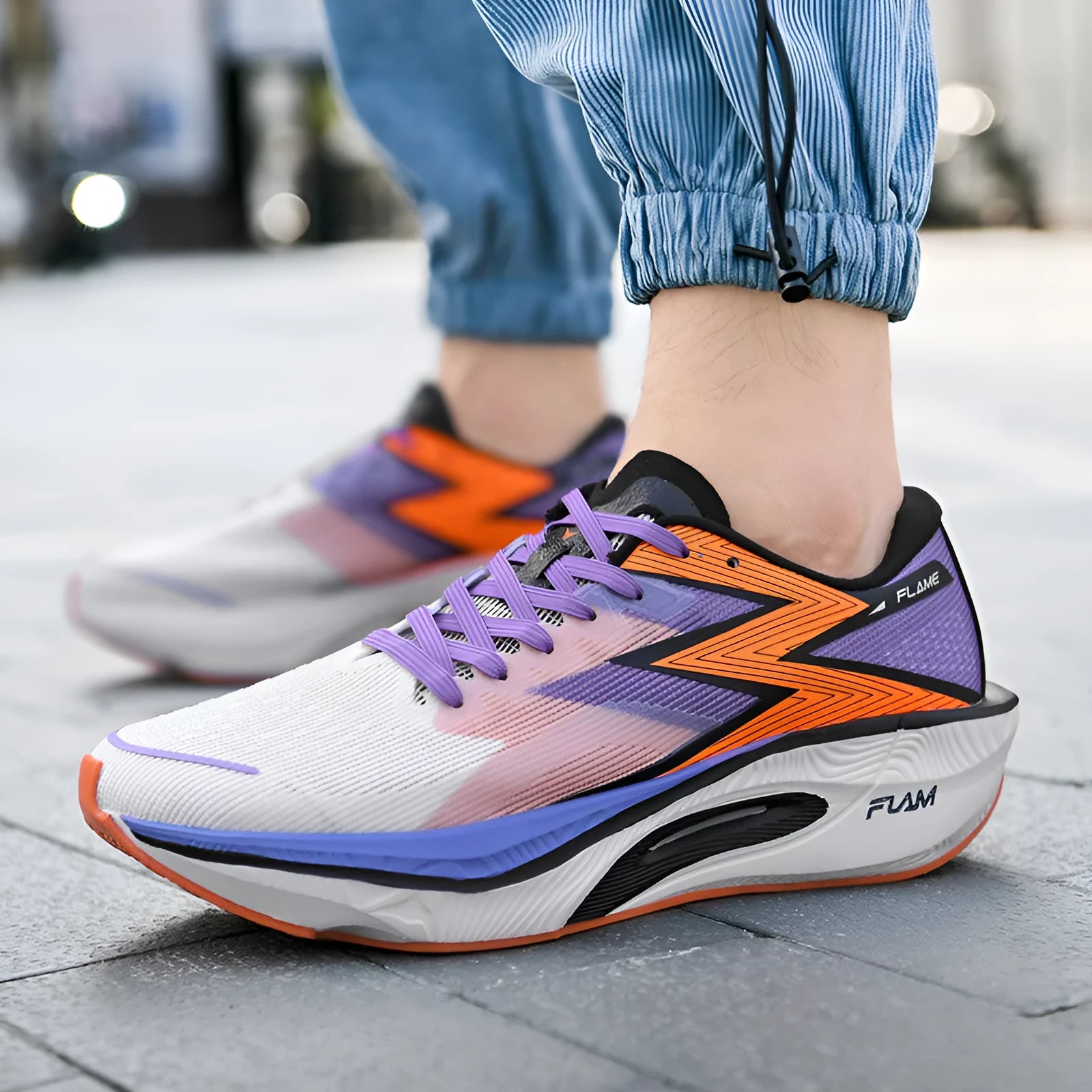 Marathon running shoes with carbon plate in orange colour on a white background