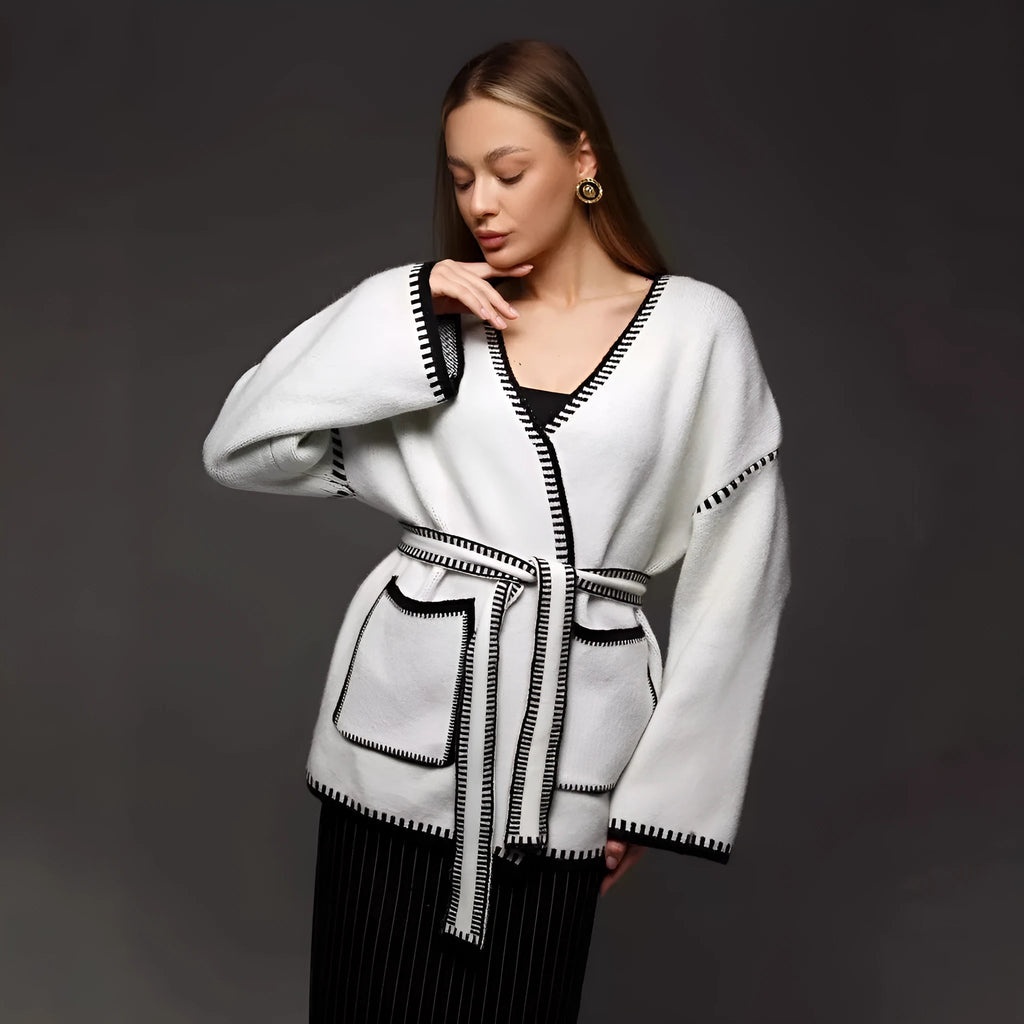 Loose black lace-up knitted cardigan sweater coat with long sleeves.