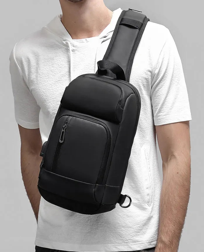 Black PVC outdoor shoulder bag with zipper, internal pockets, and an air cushion shoulder strap.
