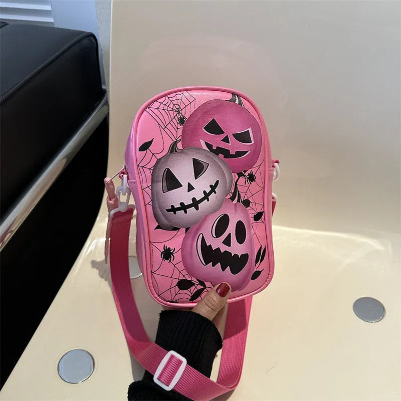 Halloween graffiti print crossbody phone bag with cartoon pumpkins, in multiple colours.