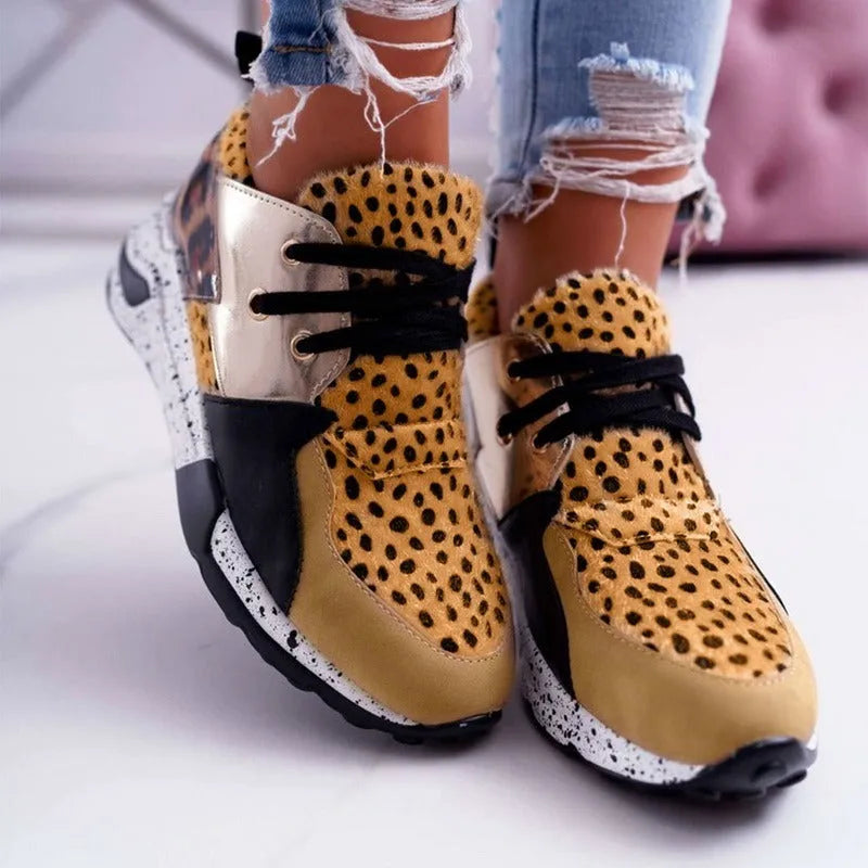 Women's casual suede sneakers with a wedge heel in black, leopard, pink, and snake pattern colours.