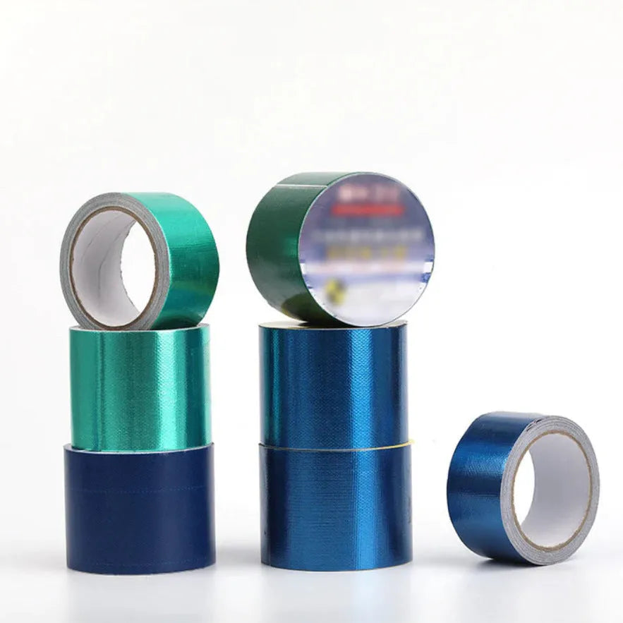 Roll of blue truck rainproof cloth repair tape 8cm wide 5m long on grey surface