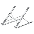 Folding flat aluminium alloy laptop bracket stand in silver with silicone pads, set at an angled position on a desk