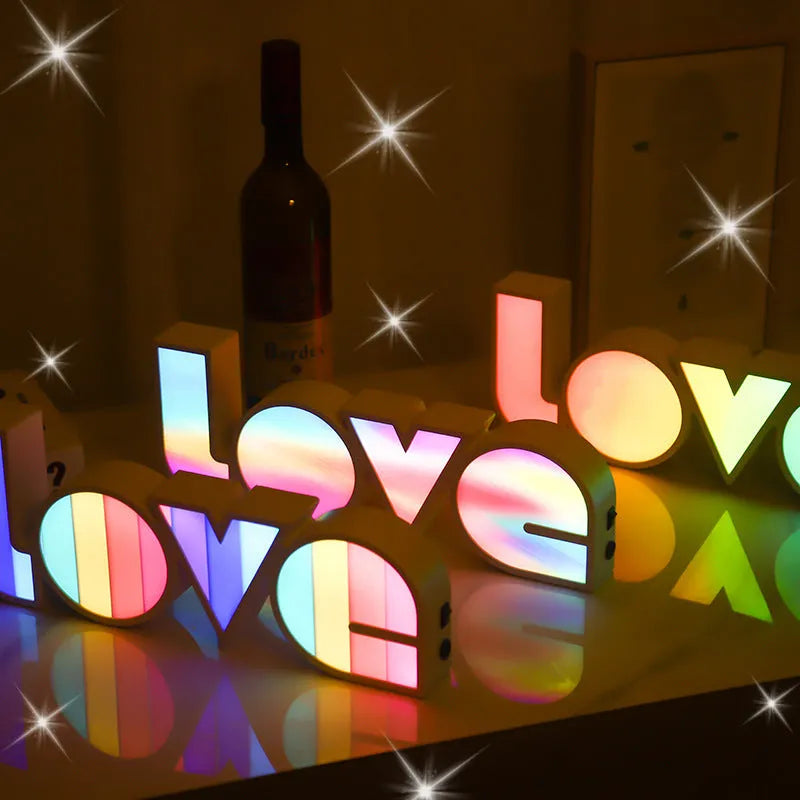 Rainbow style LED LOVE decorative table lamp with plastic shade on a table