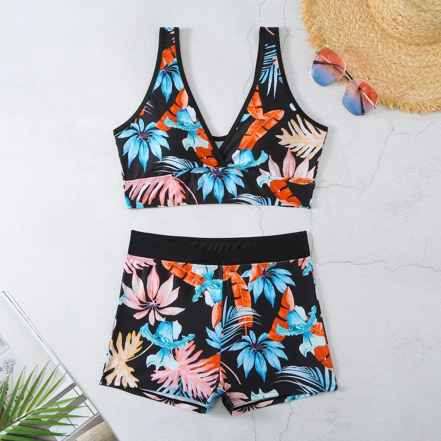 Women's two-piece printed boxer swimsuit set in a multi-colour pattern, showing sleeveless top and briefs.