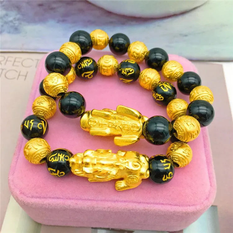 Vietnamese sand gold gold-plated brave bracelet with black beads on display