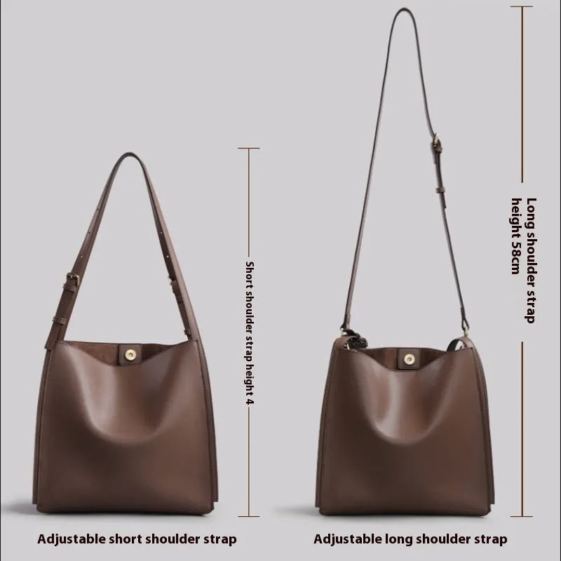 Brown genuine leather women's retro bucket bag with double shoulder straps showing interior organisation compartments
