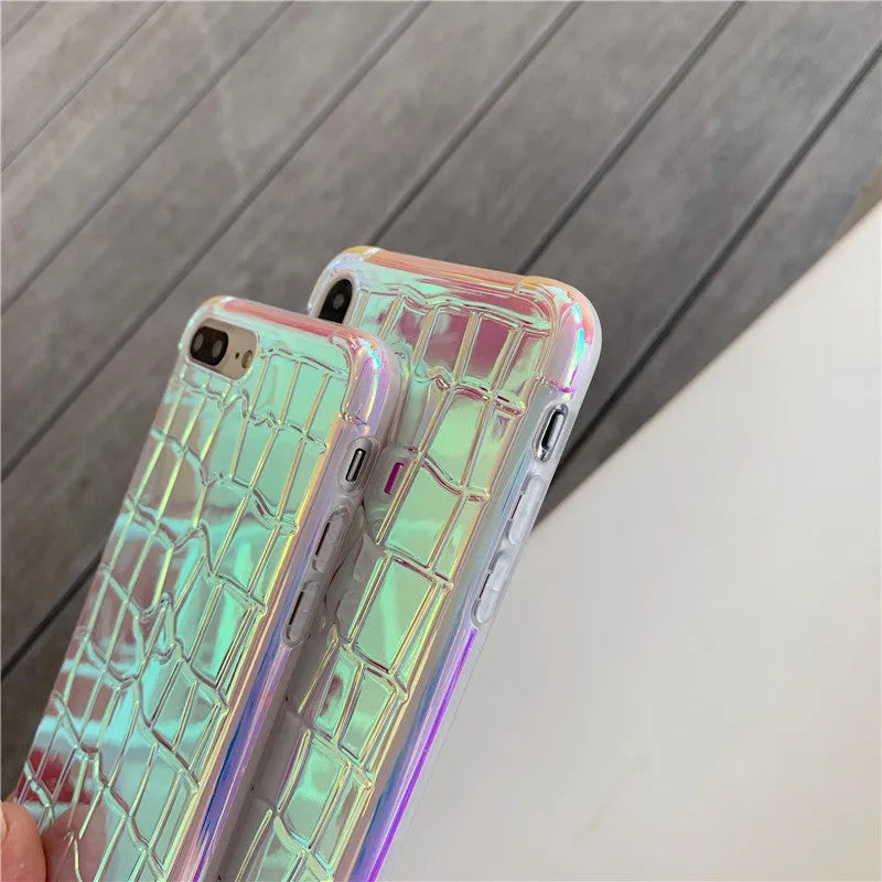 Glossy silver silicone phone case with a laser-etched irregular texture for iPhone, showing raised camera protection.