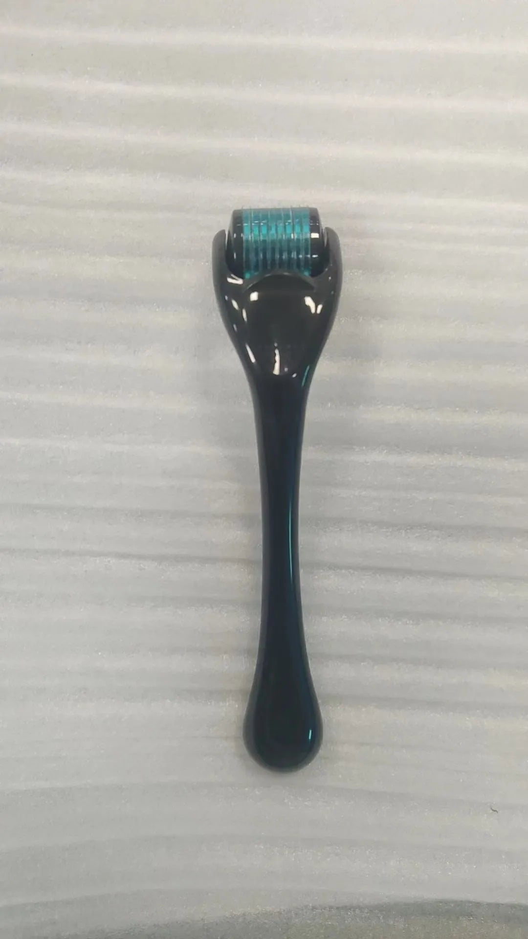 540 micro needle derma roller with black handle and purple wheel, showing adjustable needle sizes.